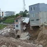 Severely damaged urban buildings after a landslide in Mocoa, Colombia, showcasing destruction.