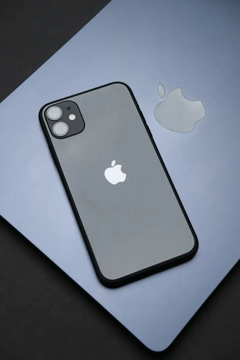 Stylish Apple iPhone on a MacBook, showcasing modern technology and design.