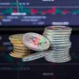 Close-up of cryptocurrency coins with a market graph background.