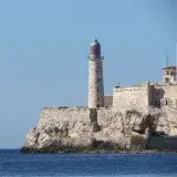 Majestic view of El Morro Lighthouse against the clear blue sky in La Habana, Cuba.