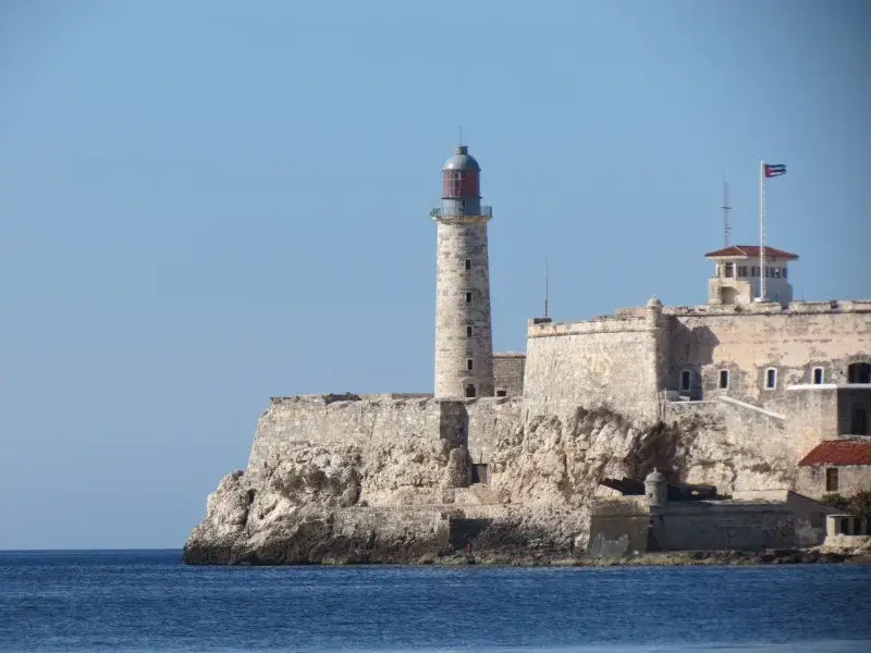 Majestic view of El Morro Lighthouse against the clear blue sky in La Habana, Cuba.