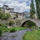 Charming medieval stone bridge over a river in Sallent de Gállego, Spain.