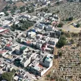 Drone shot showcasing the urban landscape and cemetery in Estado de México, México.