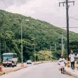 Street scene in Santa Cruz del Norte, Cuba with people and vehicles on a sunny day