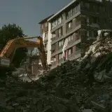 Excavator removing rubble from a collapsed building area in Antakya, Türkiye.