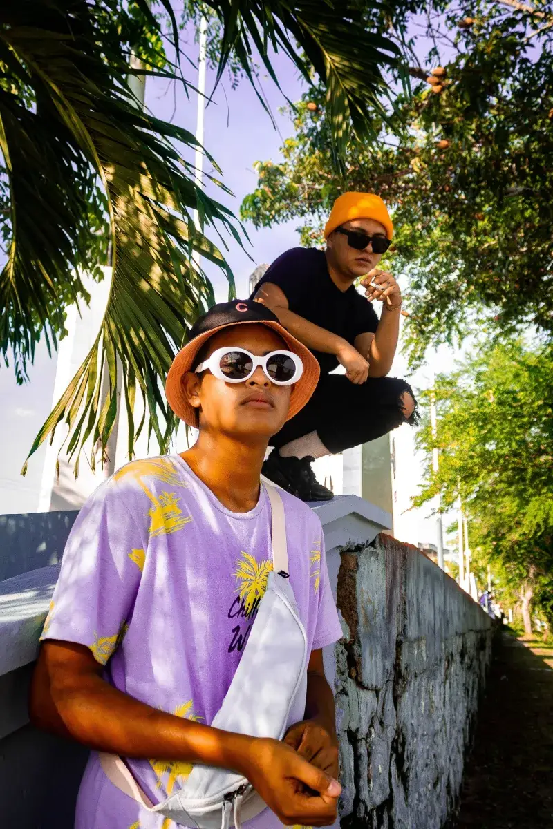 Stylish young men posing under palm trees in Túxpam de Rodríguez Cano, Veracruz, Mexico.