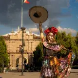 A vibrant Catrina figure dances in Toluca, Mexico, embodying the Day of the Dead spirit.