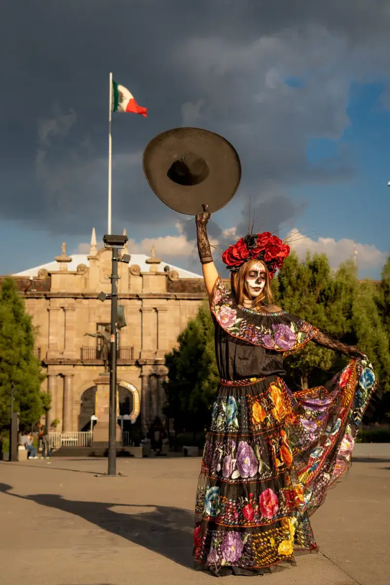 A vibrant Catrina figure dances in Toluca, Mexico, embodying the Day of the Dead spirit.