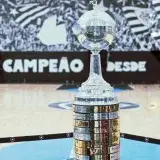 Copa Libertadores trophy displayed on an indoor basketball court, capturing its grandeur and detail.