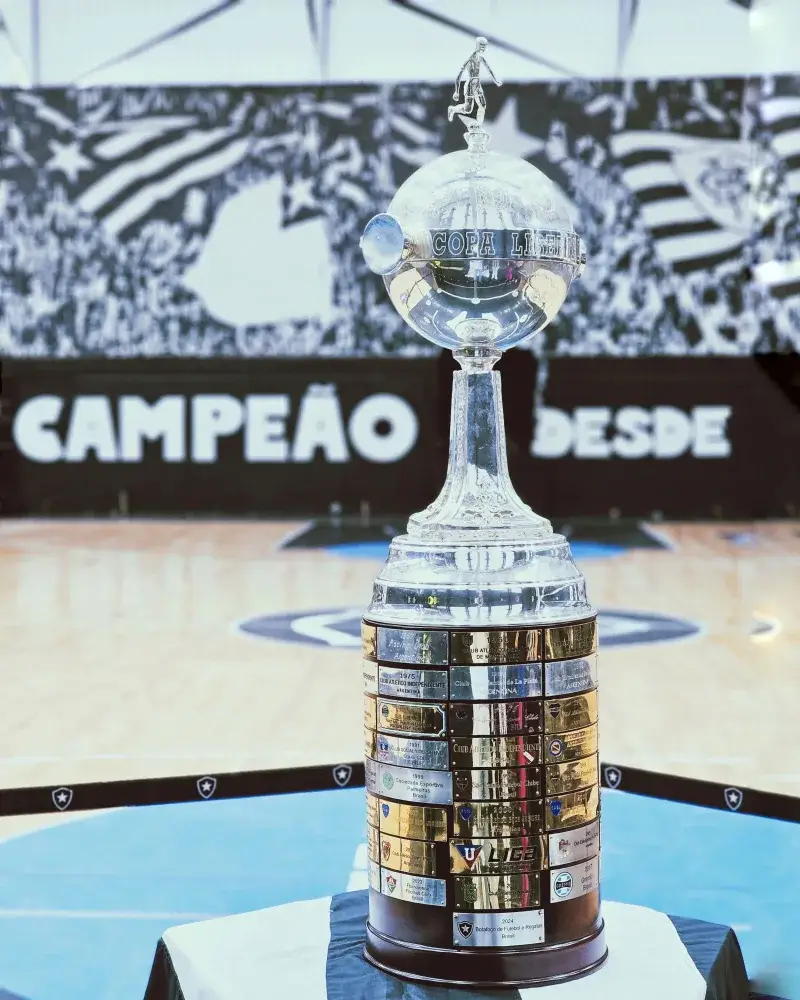 Copa Libertadores trophy displayed on an indoor basketball court, capturing its grandeur and detail.