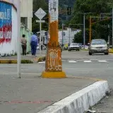 Vibrant street view in Mérida, Venezuela with graffiti and urban elements.