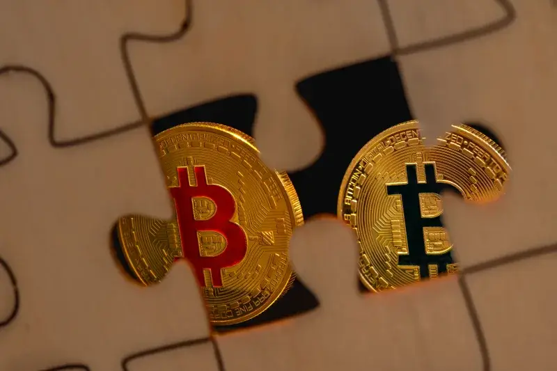 A close-up of bitcoin coins fitting into a puzzle piece, symbolizing the mystery and solution in cryptocurrency investment.