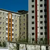 Modern apartment buildings with colorful facades against a clear blue sky in Venezuela.