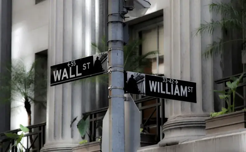 Intersección de Wall Street y William Street, mostrando señalización icónica del distrito financiero en la ciudad de Nueva York.
