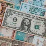 Top view of assorted paper money with American greenback representing image of President and numbers with words and signature on bill