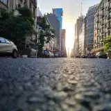 Low-angle view of a city street lined with buildings at sunrise in Buenos Aires, Argentina.
