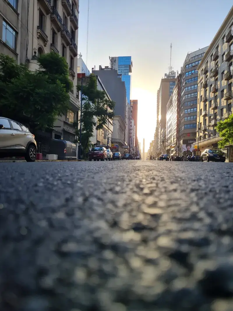 Low-angle view of a city street lined with buildings at sunrise in Buenos Aires, Argentina.