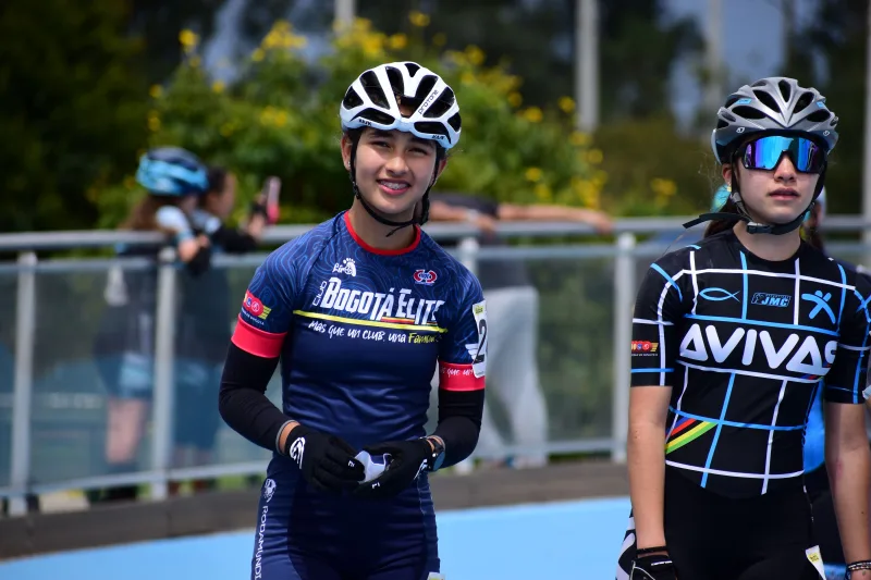 Teen cyclists in vibrant sportswear ready for a competition in Bogotá, Colombia.