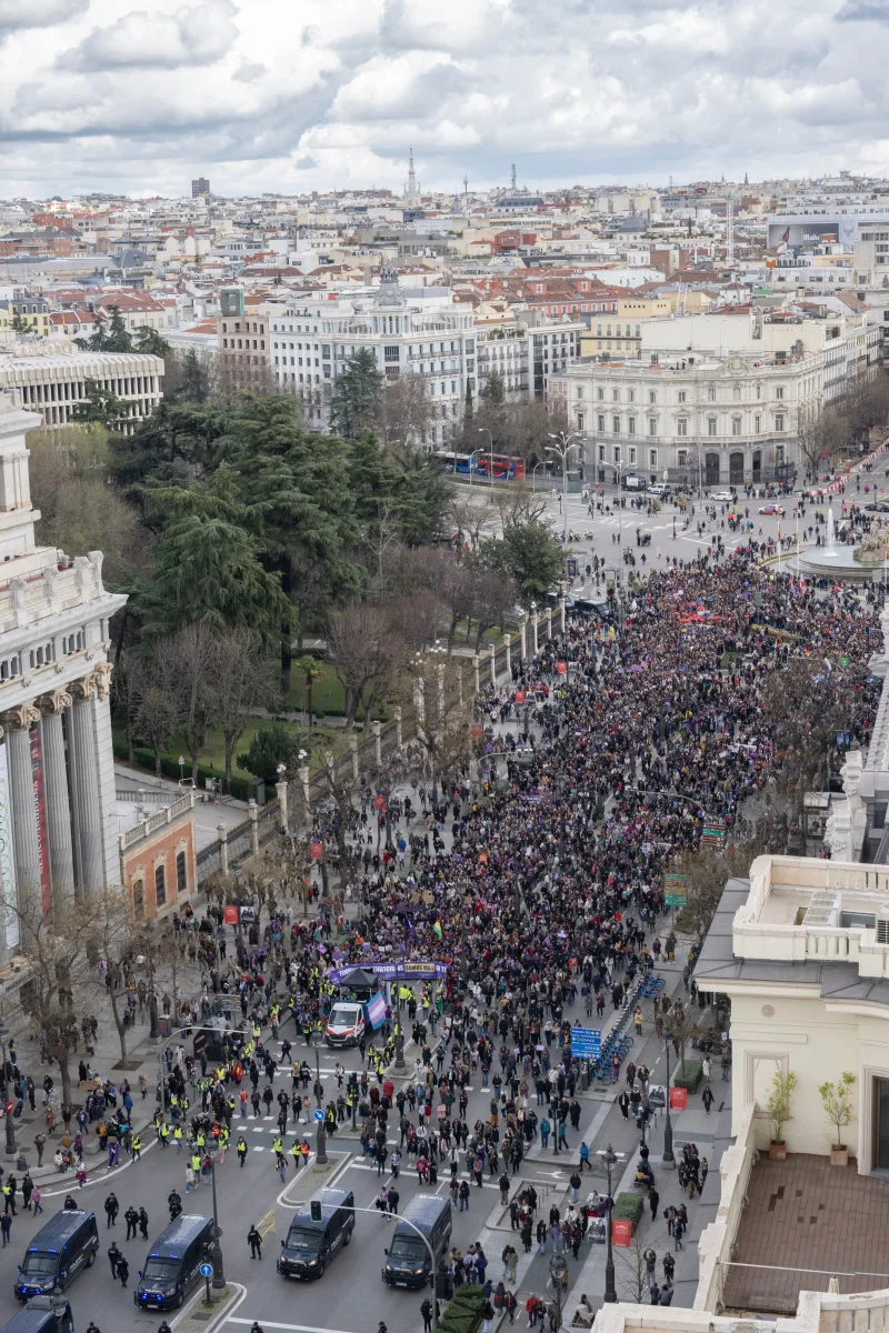 Aerial view of a large demonstration at Plaza de Cibeles, Madrid, Spain, showcasing urban architecture and civic engagement.