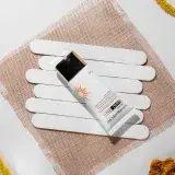 Minimalist flat lay of sunscreen SPF 60 with natural elements, enhancing beauty care theme.