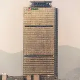 Iconic Pemex Executive Tower stands tall amidst a foggy Mexico City skyline.
