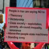 Protest in Vancouver showing support for freedom in Iran with a sign listing grievances.