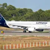 Lufthansa aircraft preparing for takeoff on a sunny day at Manises Airport, Valencia, Spain.