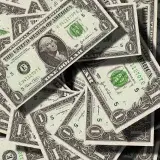 Close-up of scattered US dollar bills symbolizing finance and wealth.