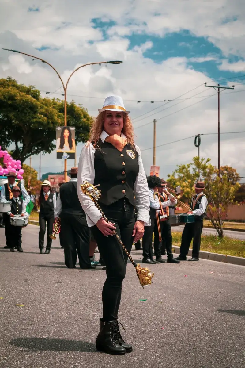 Vibrant parade featuring performers in costume on the streets of Mérida, Venezuela.