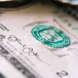 From above closeup one US dollar bill placed on table with front side up