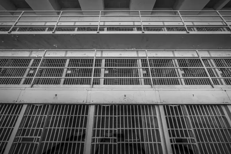 A haunting black and white view of prison cells inside Alcatraz, showcasing its storied history.