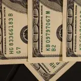 Detailed close-up shot of US dollar bills displaying serial numbers and Federal Reserve details.