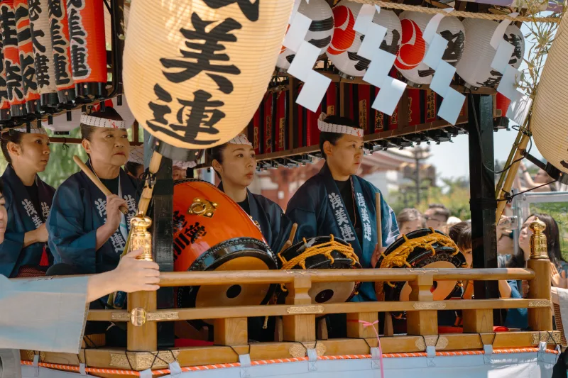 A vibrant scene of taiko drummers at a traditional Japanese festival in Tokyo.