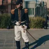 A soldier in a traditional uniform posing outside a historic building in Buenos Aires, Argentina.