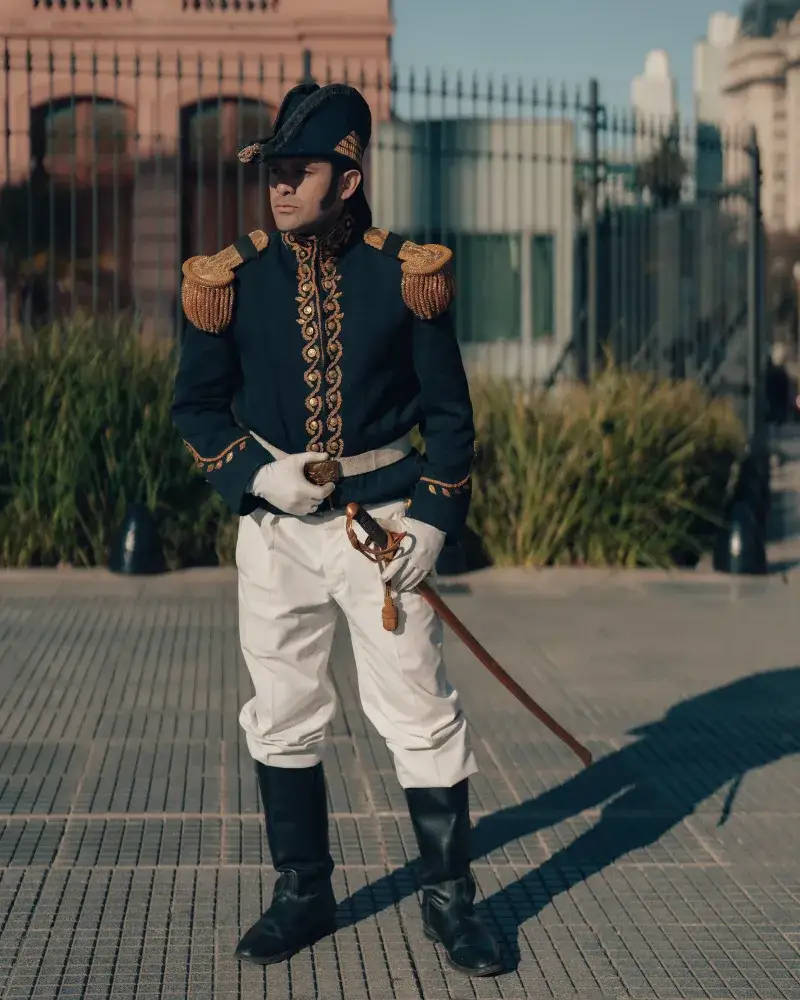 A soldier in a traditional uniform posing outside a historic building in Buenos Aires, Argentina.