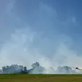 Dynamic stunt plane performing aerial acrobatics over a field in General Rodríguez, Argentina.
