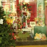 Vibrant display window featuring Christmas decorations and a tree in Catia La Mar, Venezuela.