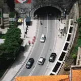 Top-down view of Santo António Tunnel in Porto with city traffic and red rooftops.