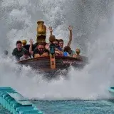 Thrilling water ride at Europa Park with people experiencing a splash landing.