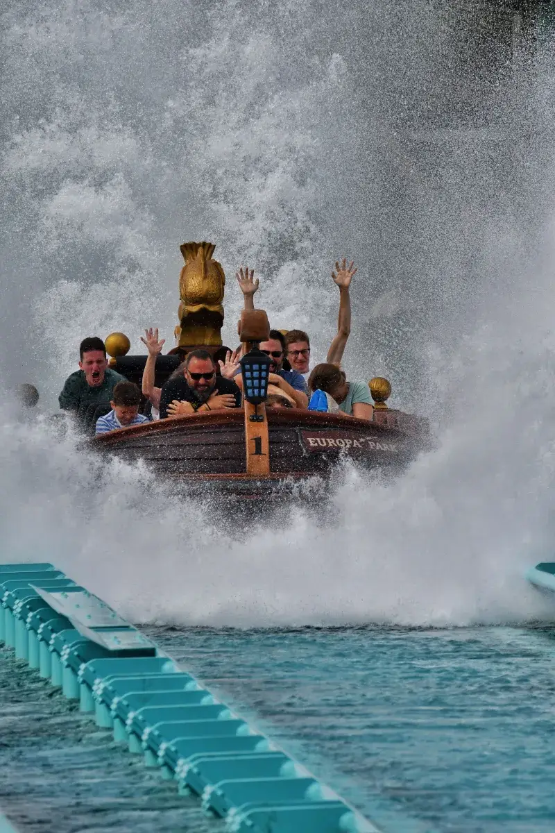 Thrilling water ride at Europa Park with people experiencing a splash landing.