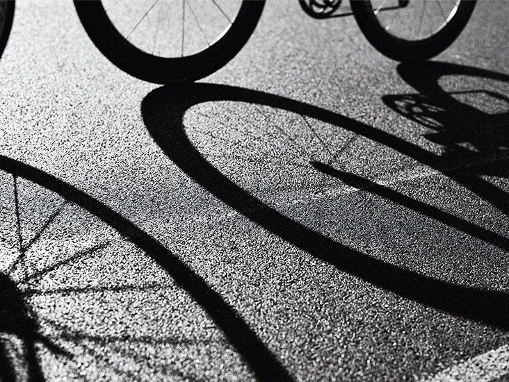 shadow of bike wheels on asphalt