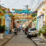 Colorful alley in Getsemani, Cartagena, Colombia, adorned with vibrant decorations and lively atmosphere.