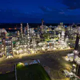 Dramatic aerial shot of an illuminated oil refinery at night in Rosemount, MN.