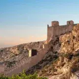 Scenic view of Alcazaba fortress on a cliff during sunset in Almería, Spain.