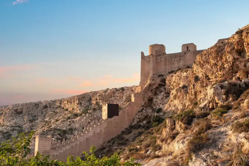 Scenic view of Alcazaba fortress on a cliff during sunset in Almería, Spain.