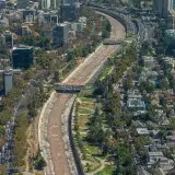 Aerial shot of Santiago, Chile featuring the cityscape and river winding through urban areas.