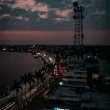 Aerial view of Túxpam de Rodríguez Cano, Mexico at dusk with vibrant streetlights and cityscape.