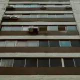 Low angle view of a modern apartment building facade with windows, Mérida, Venezuela.