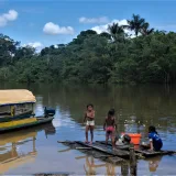 Children enjoying a sunny day by the river in San Martín, Amazonas, Colombia.