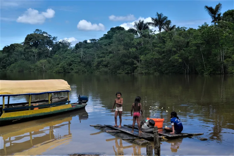 Children enjoying a sunny day by the river in San Martín, Amazonas, Colombia.